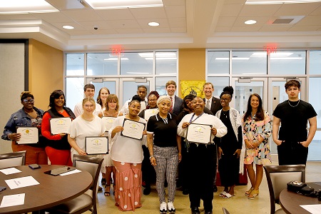 Twelve students enrolled in East Mississippi Community College’s Adult Education program were inducted into the National Adult Education Honor Society in a March 31 ceremony. The inductees are accompanied by EMCC President Dr. Scott Alsobrooks and 2nd Chance MS Executive Director Zach Scruggs.