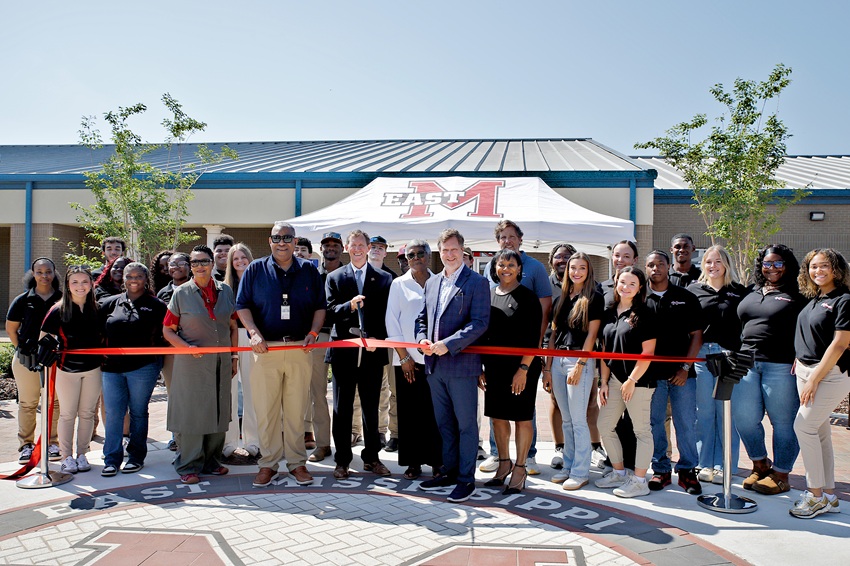 East Mississippi Community College President Dr. Scott Alsobrooks, center, cuts a ribbon to commemorate the completion of a project to construct new sidewalks, courtyards and seating areas on the college’s Golden Triangle campus. At the April 17 ribbon cutting, Alsobrooks is flanked, at left, by MDOT Public Information Officer David Kenney and EMCC Board of Trustees member Hazel Johnson. To the immediate right of Alsobrooks are EMCC Board of Trustees member Evelyn Murray and Lowndes County Board of Supervisors President Trip Hairston. 